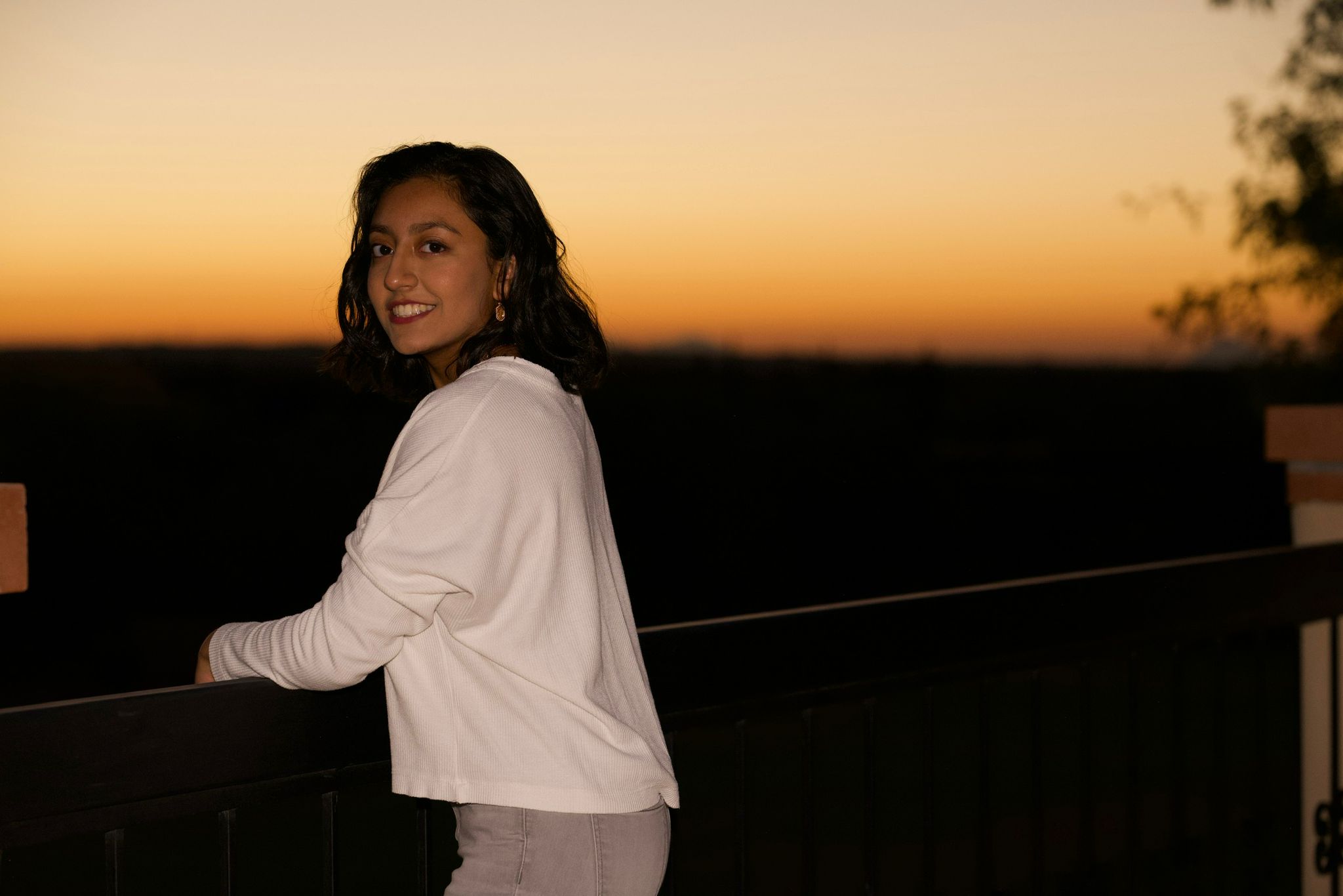 Picture of Keya with a sunset in the background.