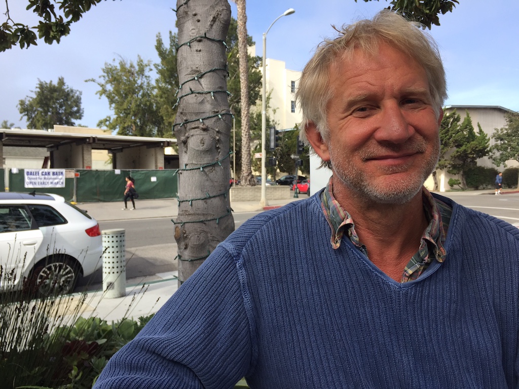Image of Alan Macy with a neighborhood street in the background.